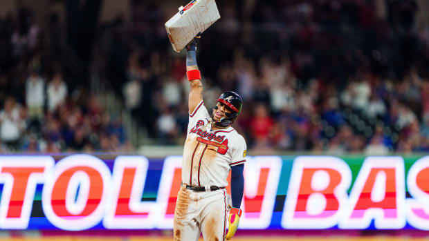 Atlanta Braves outfielder Ronald Acuña Jr celebrates after stealing his 70th base of the season in the 10th inning against the Chicago Cubs in Truist Park.